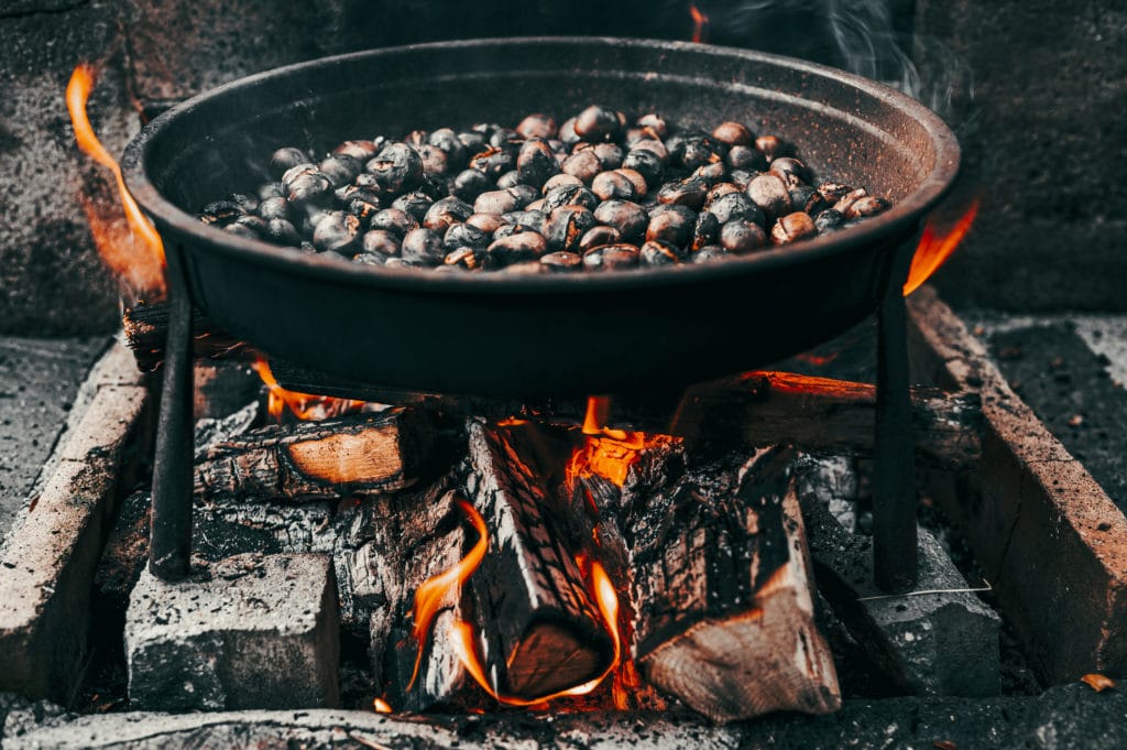closeup shot pan chestnuts roasting fire